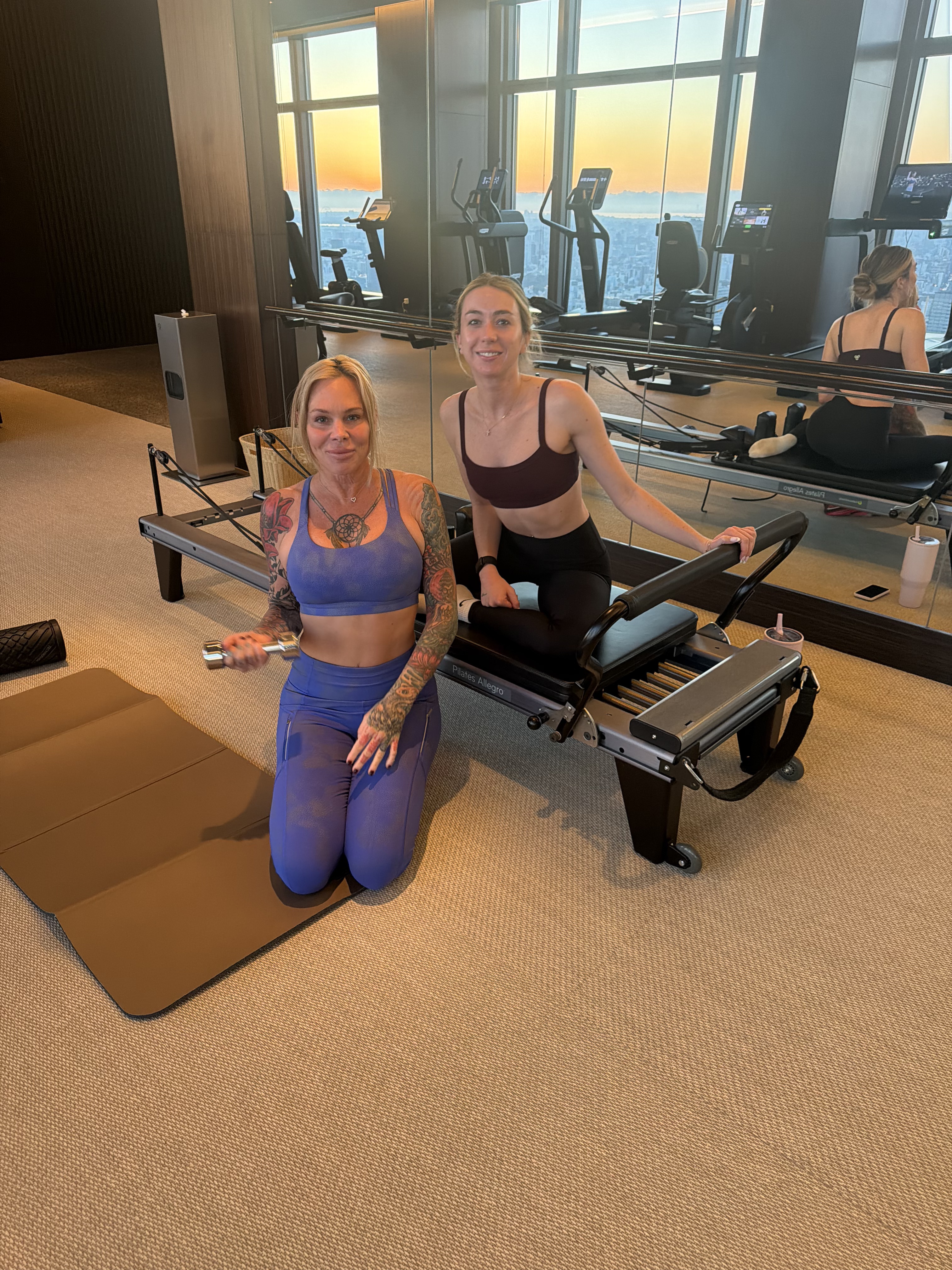Two women at the reformer in a studio